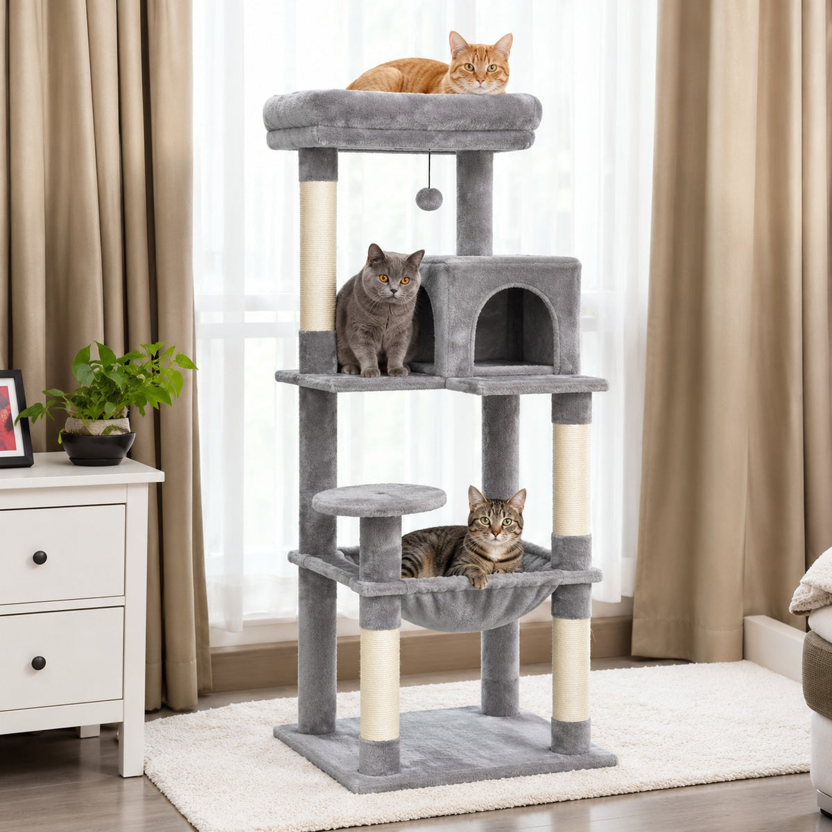 Arbre à chat gris clair devant une fenêtre, avec niche et hamac